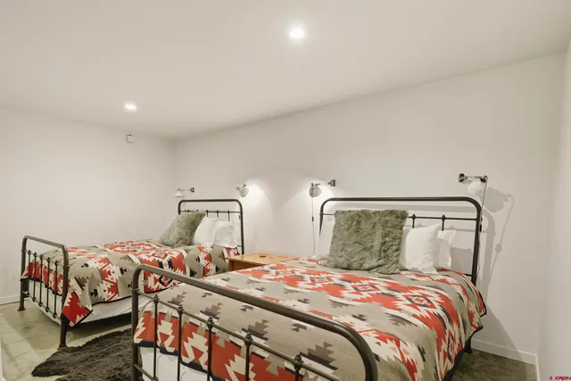 a bedroom with furniture and a wooden floor