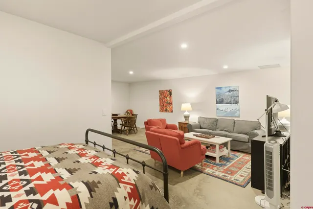 a front view of a house with a yard and potted plants