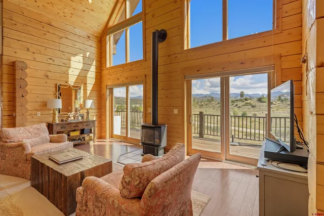 a living room with furniture a large window