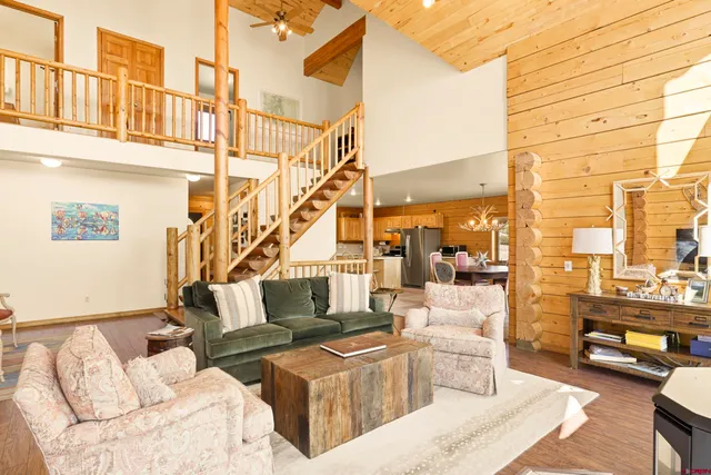 a living room with couches a coffee table and next to a window