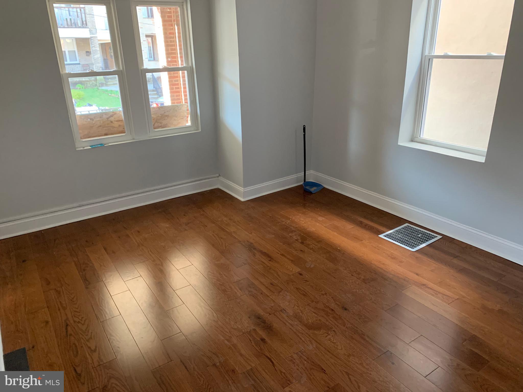 5435 Angora Terrace Philadelphia, PA 19143 - Photo 3 of 7 an empty room with wooden floor and windows