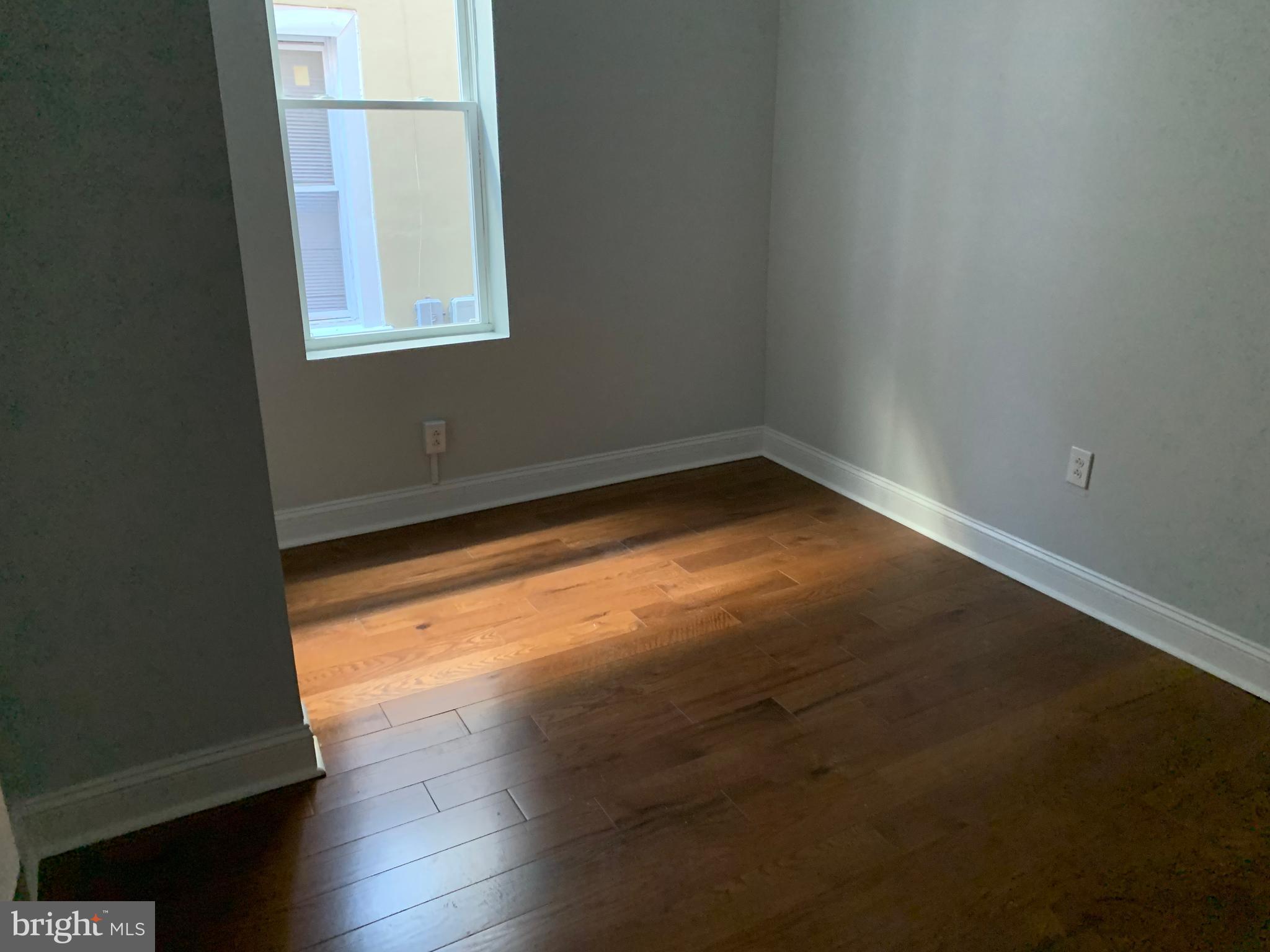 5435 Angora Terrace Philadelphia, PA 19143 - Photo 6 of 7 a view of empty room with wooden floor and fan