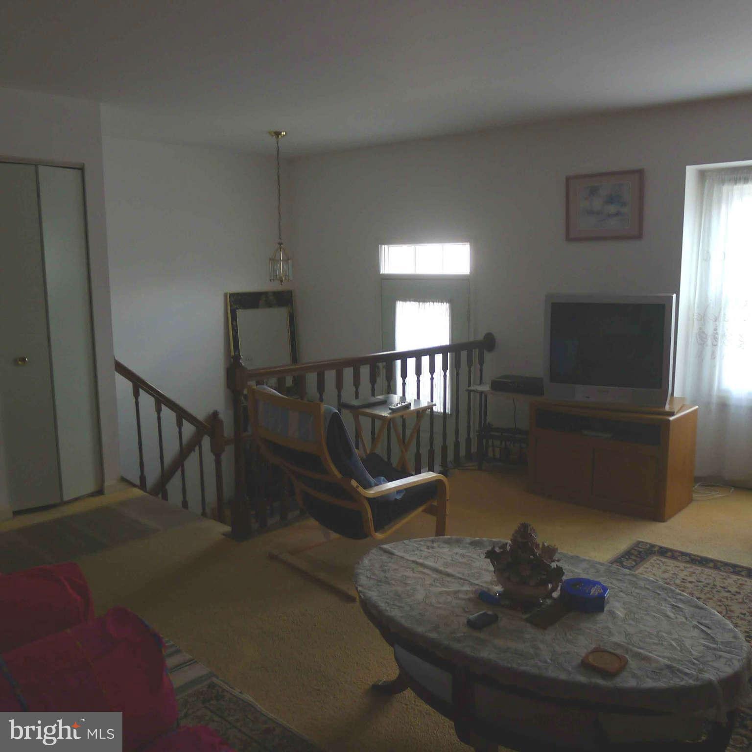 14430 Bakersfield Court Silver Spring, MD 20906 - Photo 3 of 7 a living room with furniture and a wooden floor