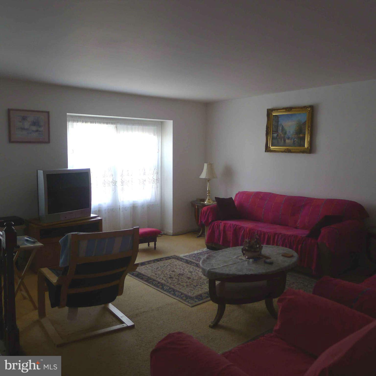 14430 Bakersfield Court Silver Spring, MD 20906 - Photo 4 of 7 a living room with furniture and a flat screen tv