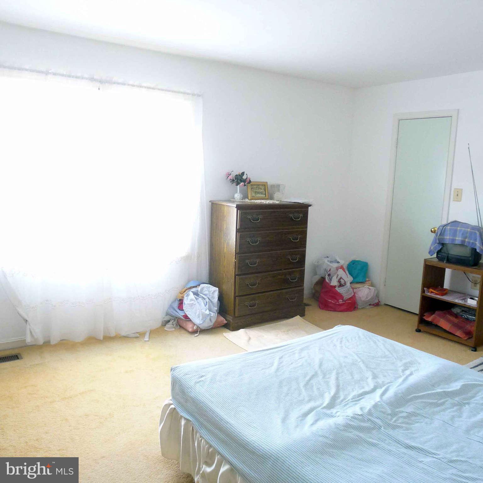 14430 Bakersfield Court Silver Spring, MD 20906 - Photo 5 of 7 a bedroom with a bed and a window