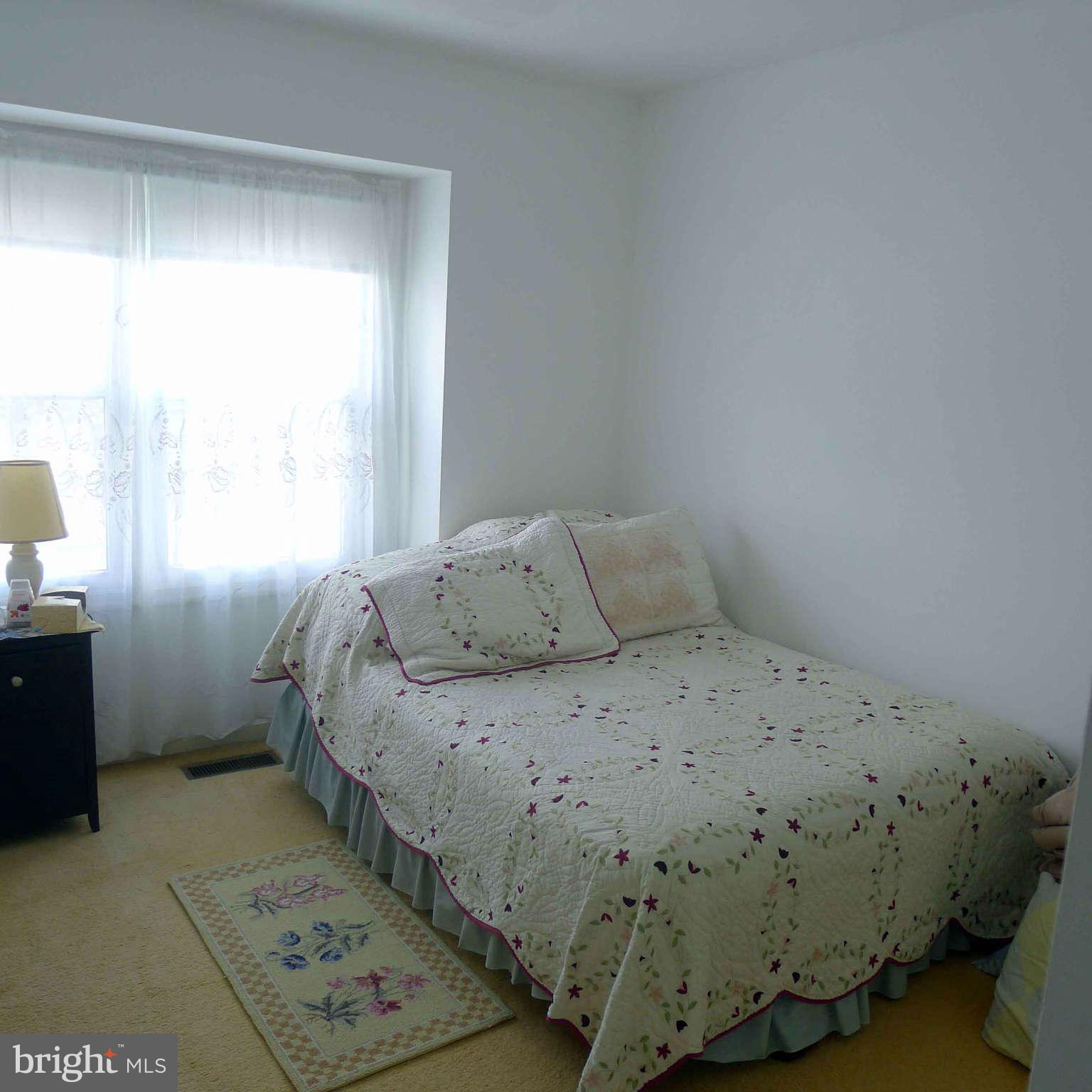 14430 Bakersfield Court Silver Spring, MD 20906 - Photo 7 of 7 a bedroom with a bed and a window