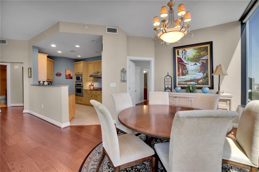 2828 Peachtree Road Northwest, Unit 1901 Atlanta, GA 30305 - Photo 14 of 35 a view of a dining room with furniture and wooden floor