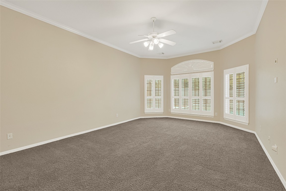 3906 Point Cuero Court Katy, TX 77494 - Photo 19 of 40 an empty room with chandelier fan and windows