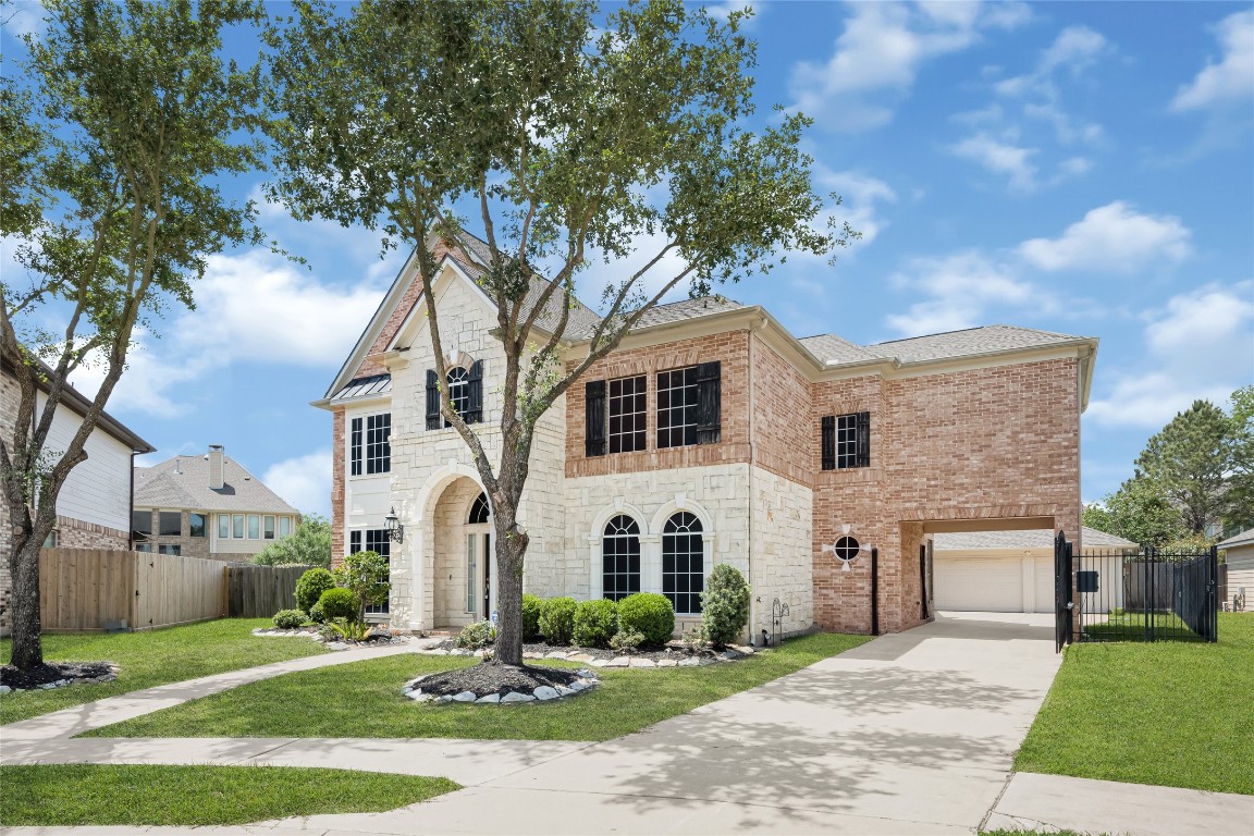 3906 Point Cuero Court Katy, TX 77494 - Photo 2 of 40 a front view of a house with a yard and garage