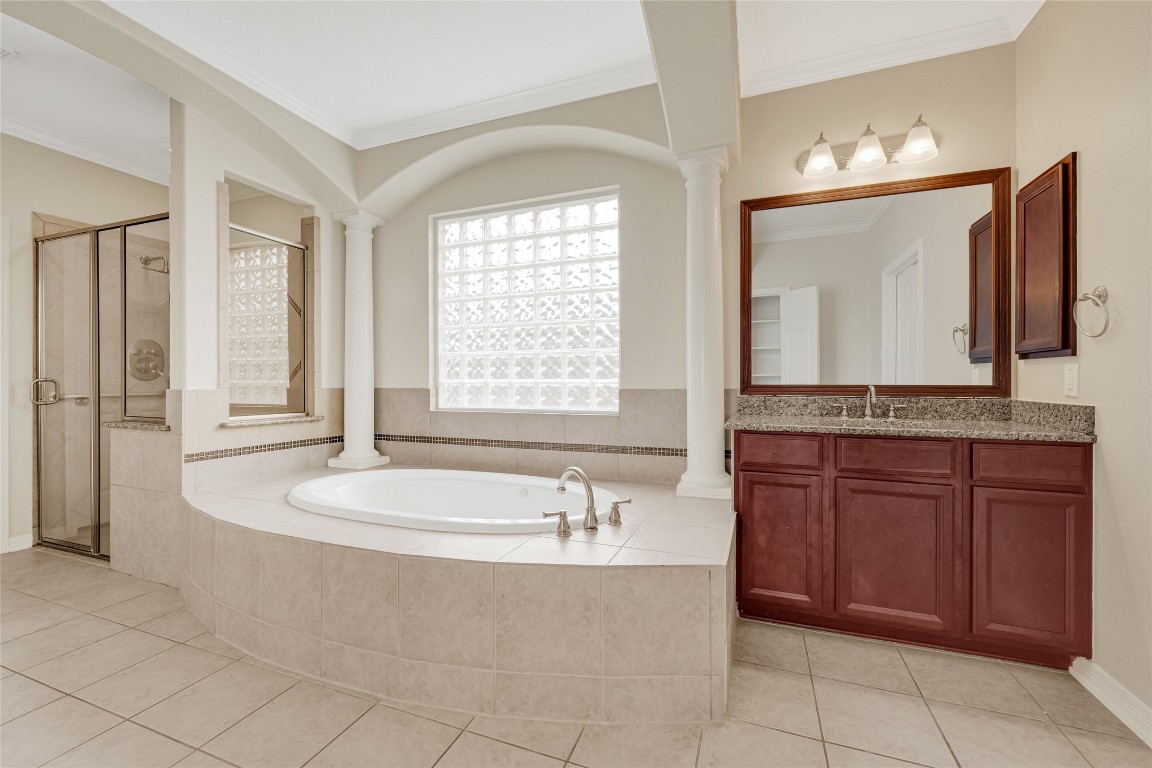 3906 Point Cuero Court Katy, TX 77494 - Photo 21 of 40 a bathroom with a granite countertop bathtub sink and mirror