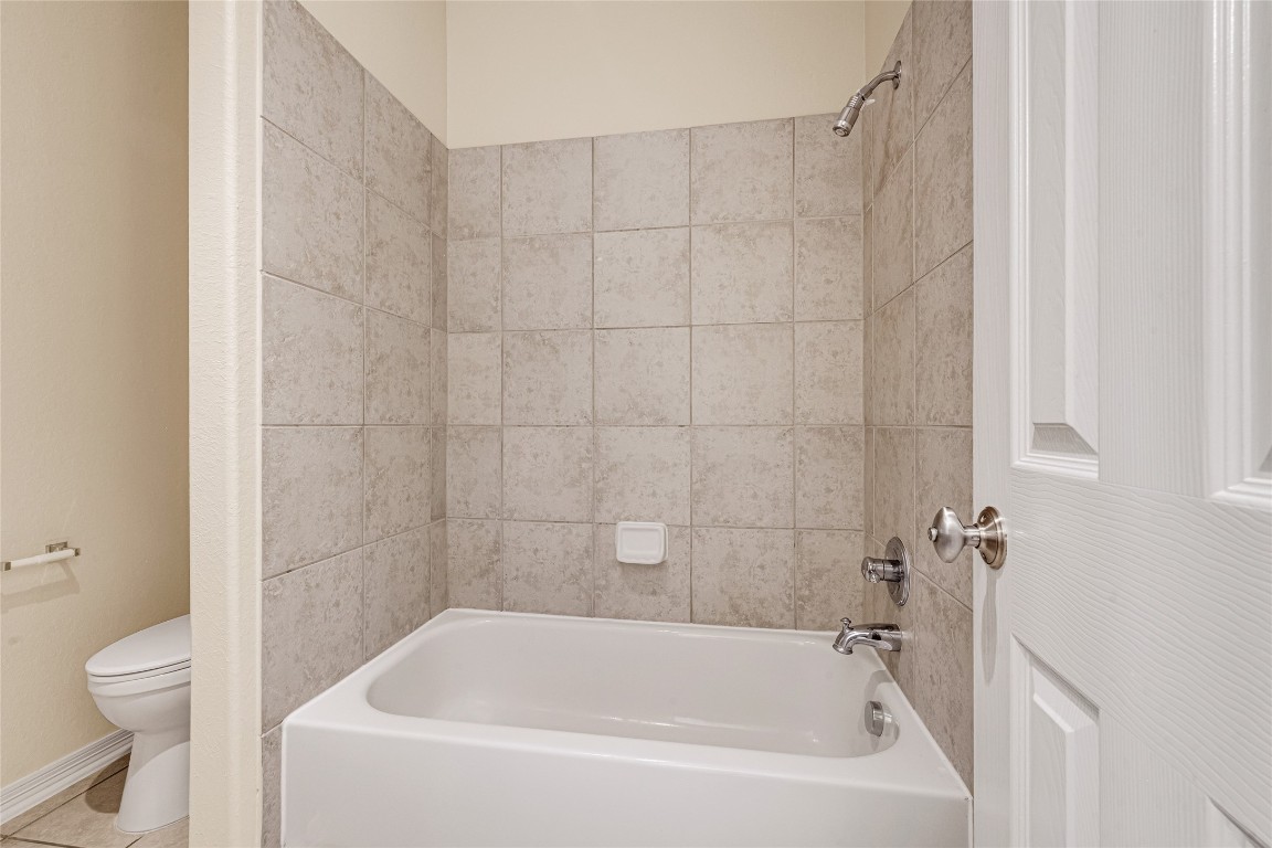 3906 Point Cuero Court Katy, TX 77494 - Photo 32 of 40 a white bath tub sitting next to a white toilet and a shower