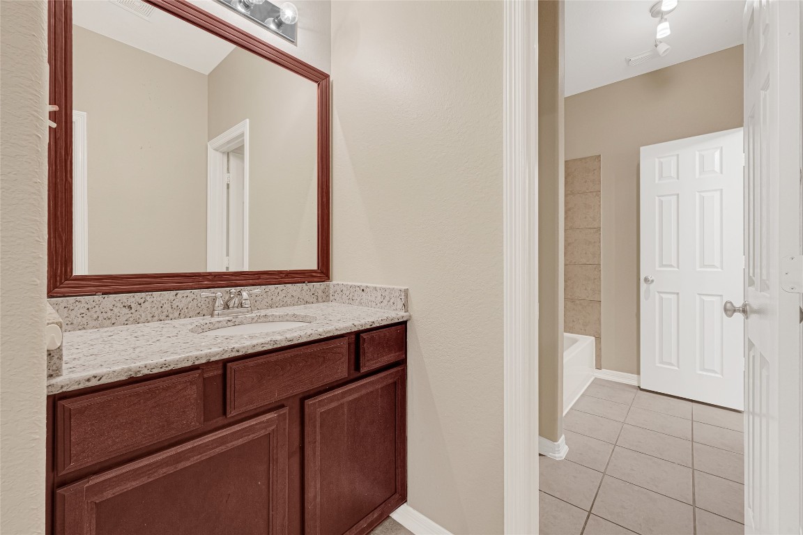 3906 Point Cuero Court Katy, TX 77494 - Photo 33 of 40 a bathroom with a granite countertop sink and a mirror