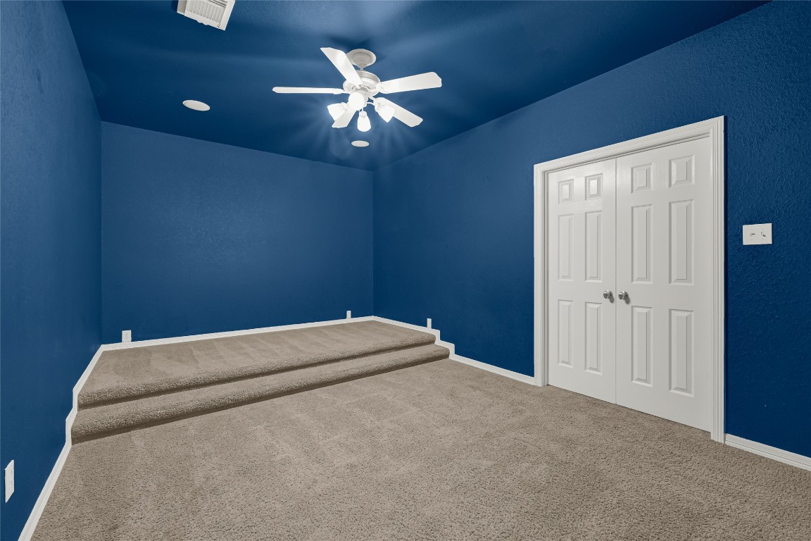 3906 Point Cuero Court Katy, TX 77494 - Photo 37 of 40 a bed room with a bed and a chandelier