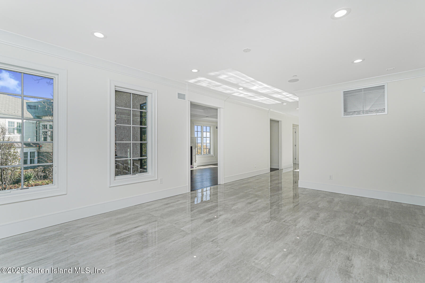 91 West Entry Road Staten Island, NY 10304 - Photo 14 of 57 an empty room with windows and entrance