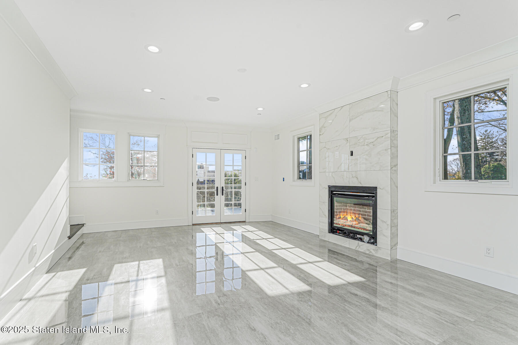 91 West Entry Road Staten Island, NY 10304 - Photo 15 of 57 a view of empty room with a fireplace and fan