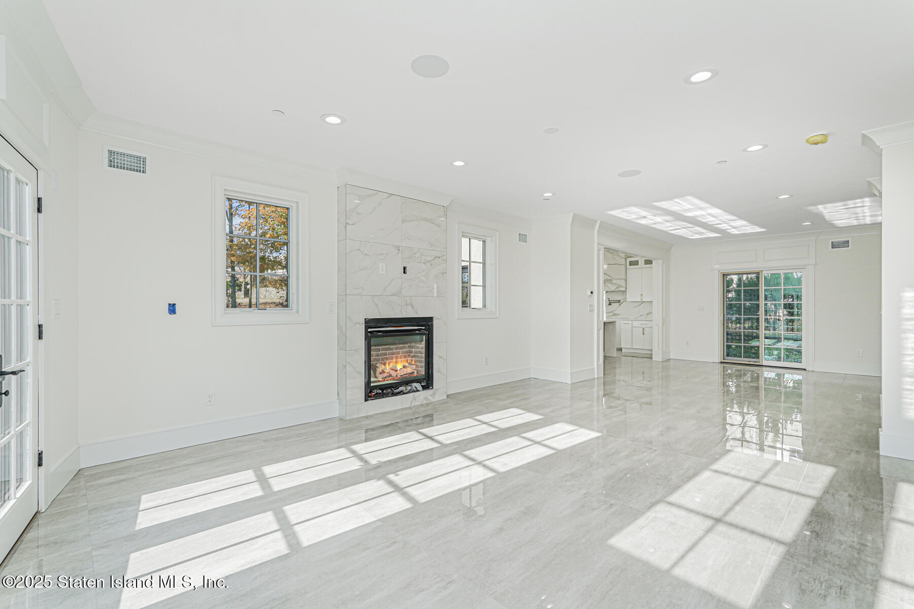 91 West Entry Road Staten Island, NY 10304 - Photo 17 of 57 a view of livingroom with hardwood floor and a fireplace