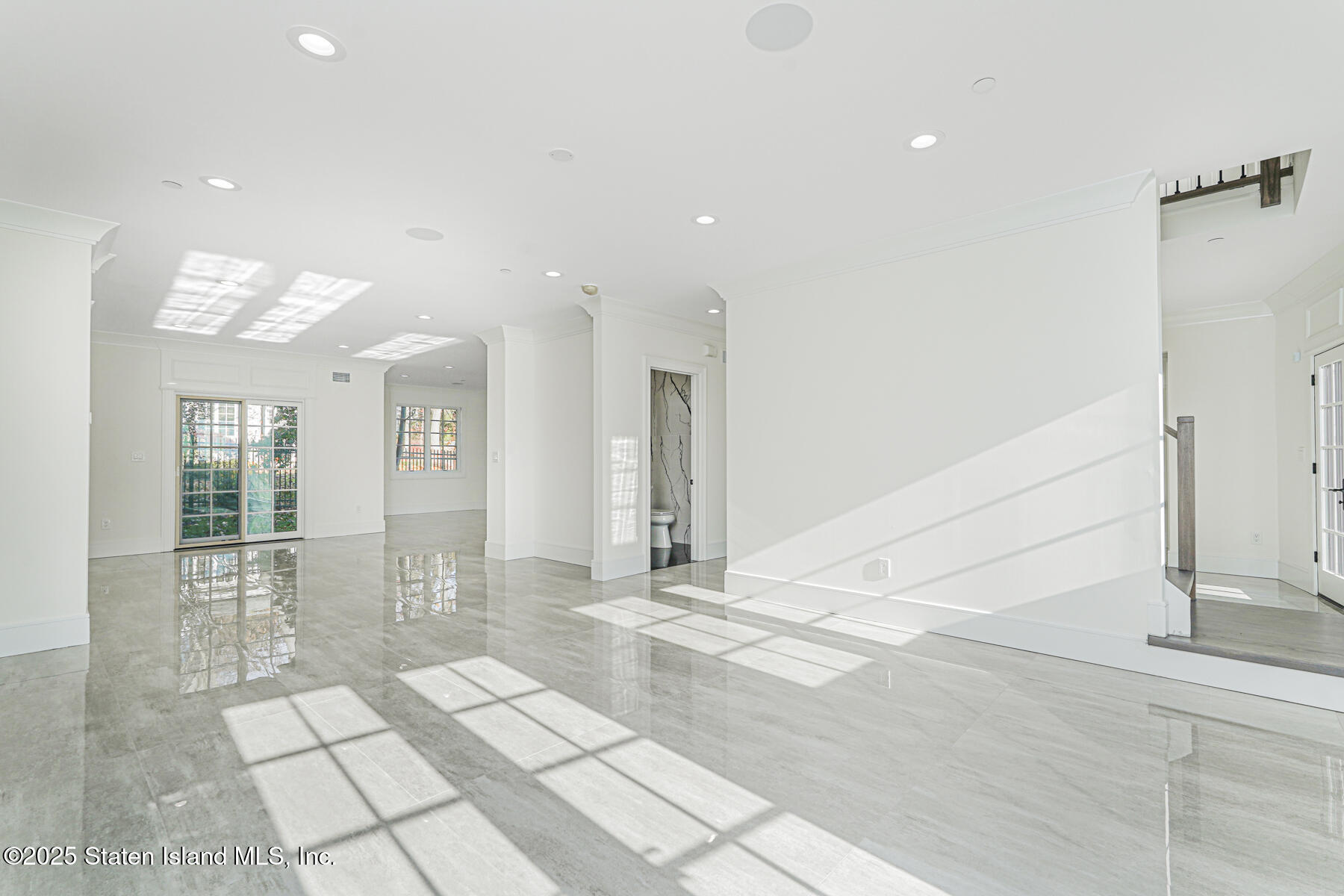 91 West Entry Road Staten Island, NY 10304 - Photo 19 of 57 a view of empty room with wooden floor and fan