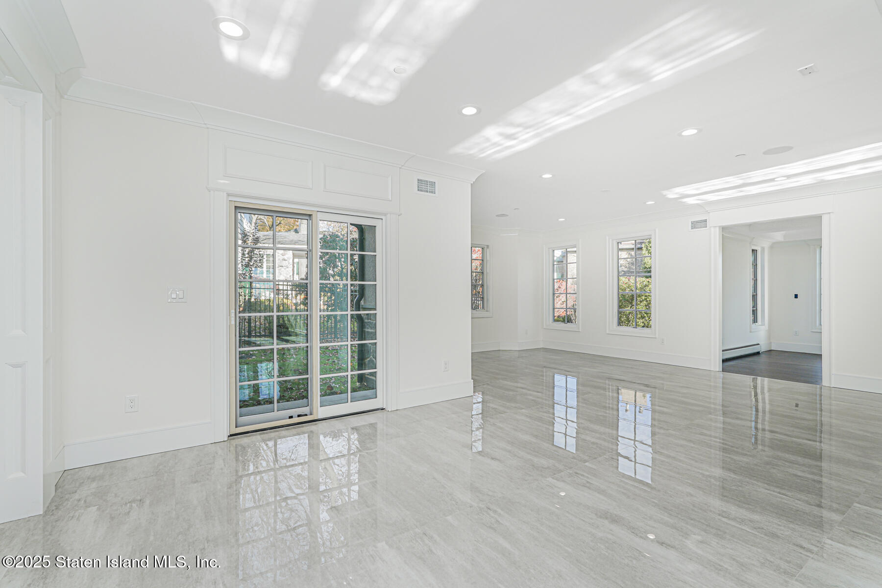 91 West Entry Road Staten Island, NY 10304 - Photo 21 of 57 a view of an empty room with wooden floor and a window