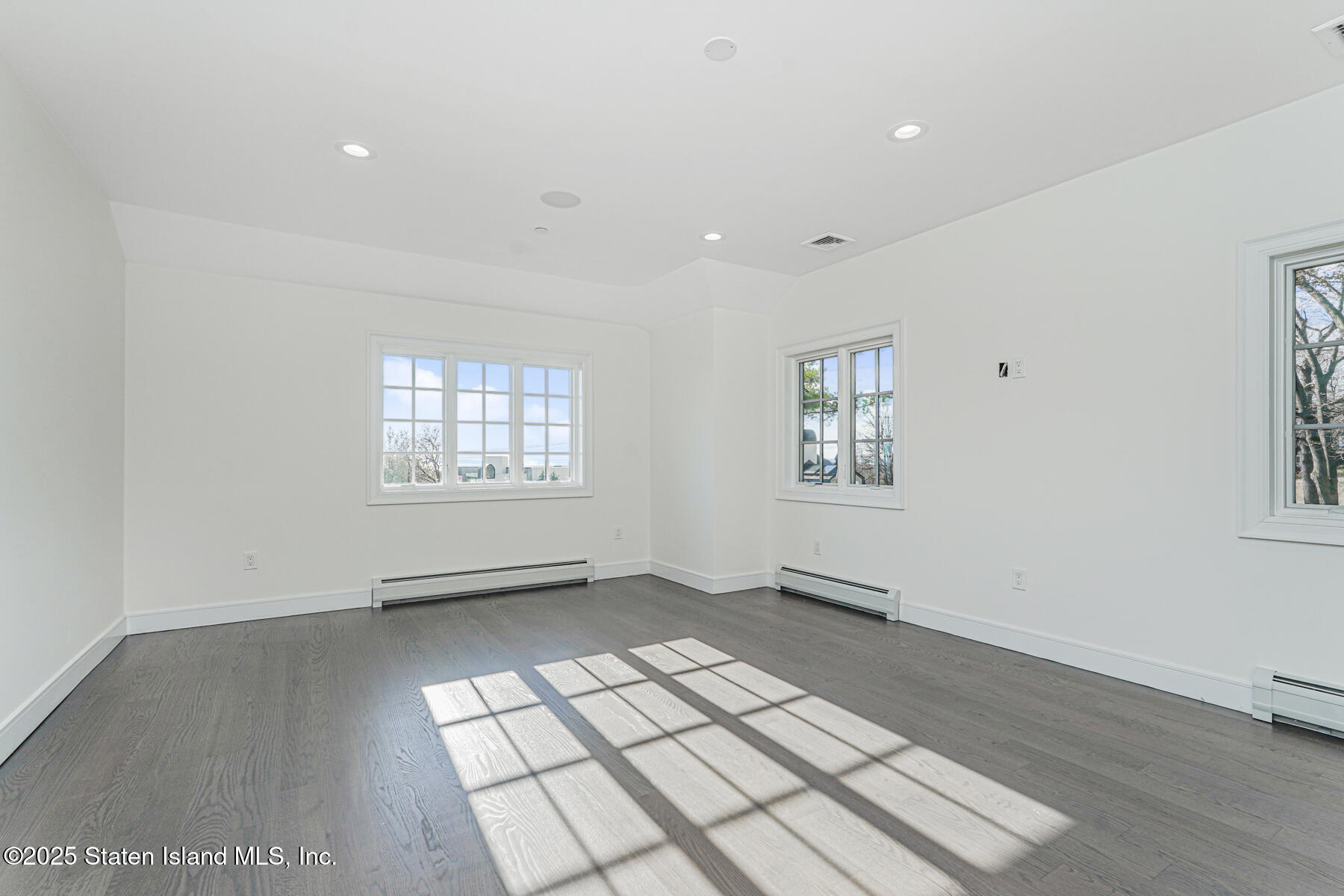 91 West Entry Road Staten Island, NY 10304 - Photo 31 of 57 wooden floor in an empty room with a window