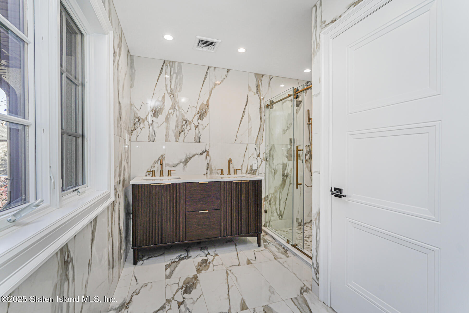 91 West Entry Road Staten Island, NY 10304 - Photo 37 of 57 a bathroom with a glass door shower and a sink