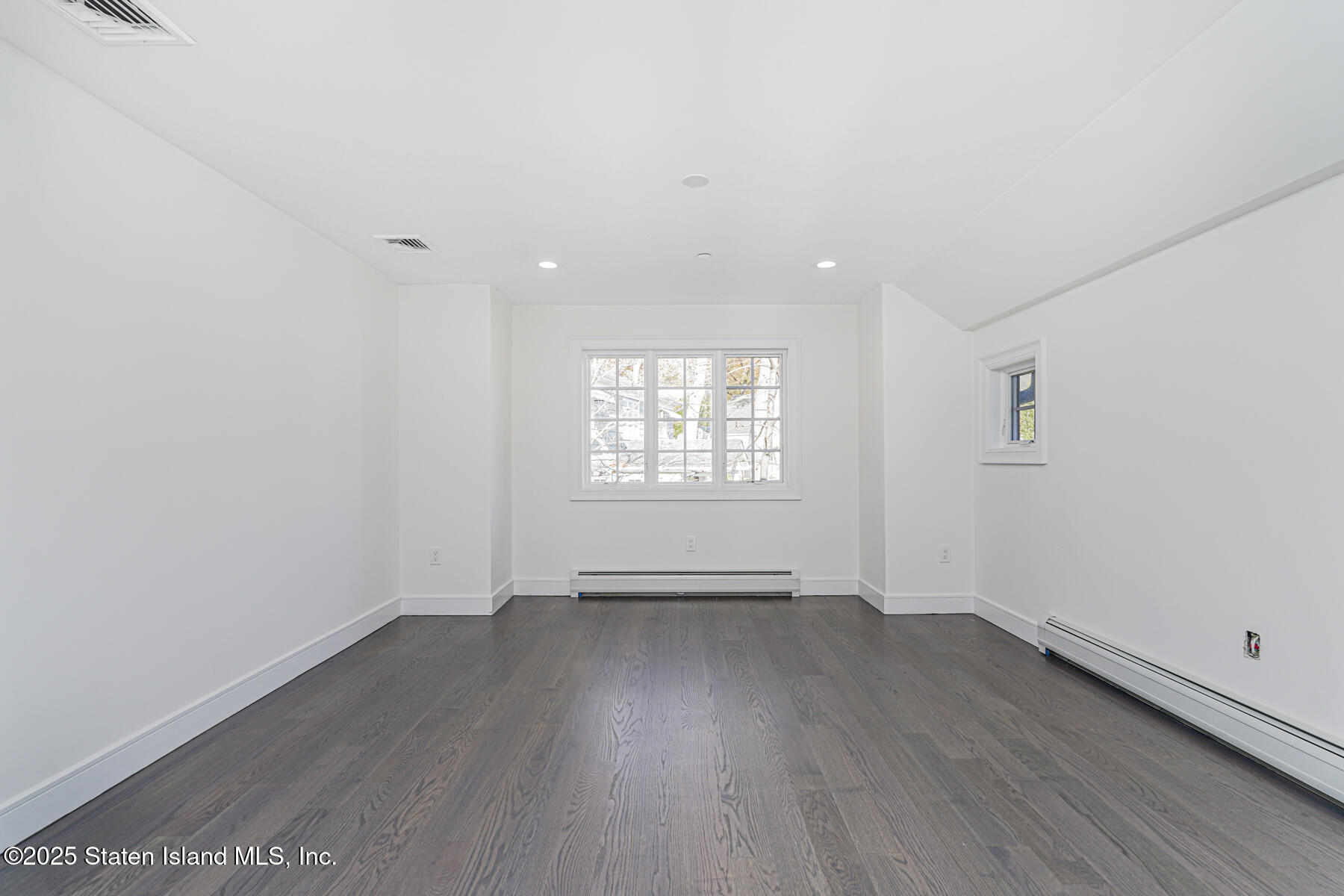 91 West Entry Road Staten Island, NY 10304 - Photo 39 of 57 an empty room with wooden floor and windows