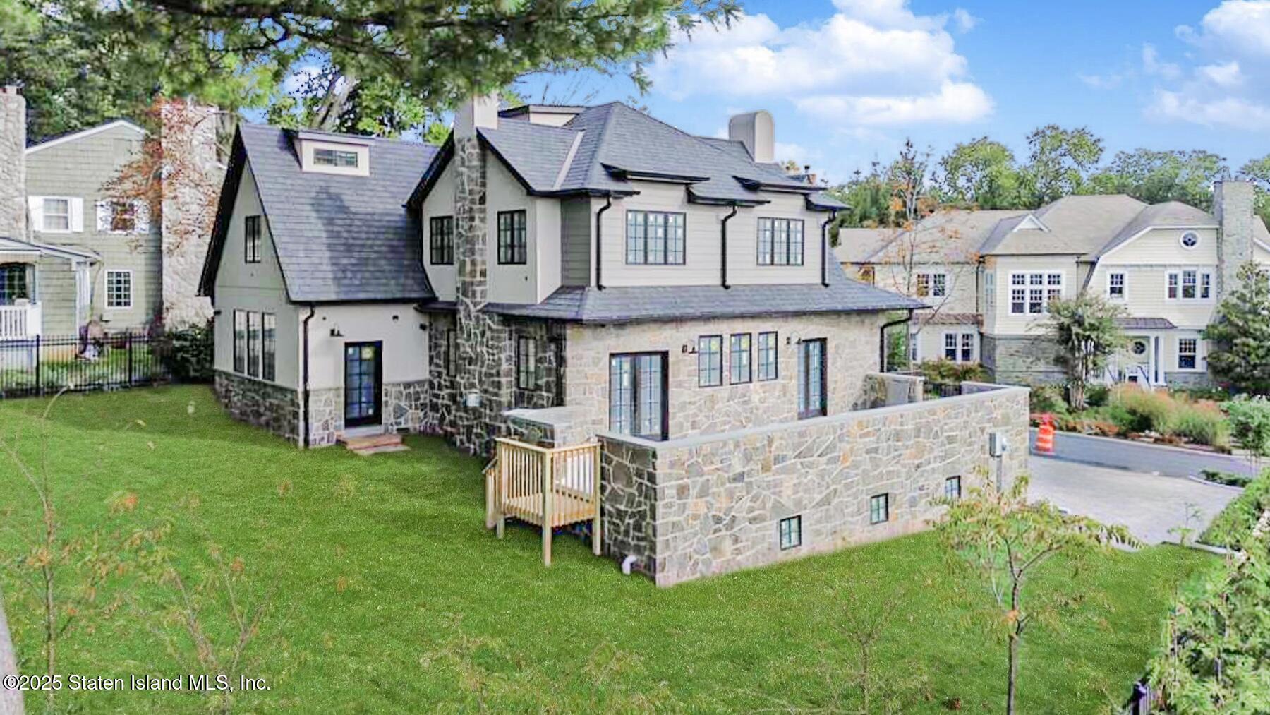 91 West Entry Road Staten Island, NY 10304 - Photo 4 of 57 a front view of a house with a garden and deck