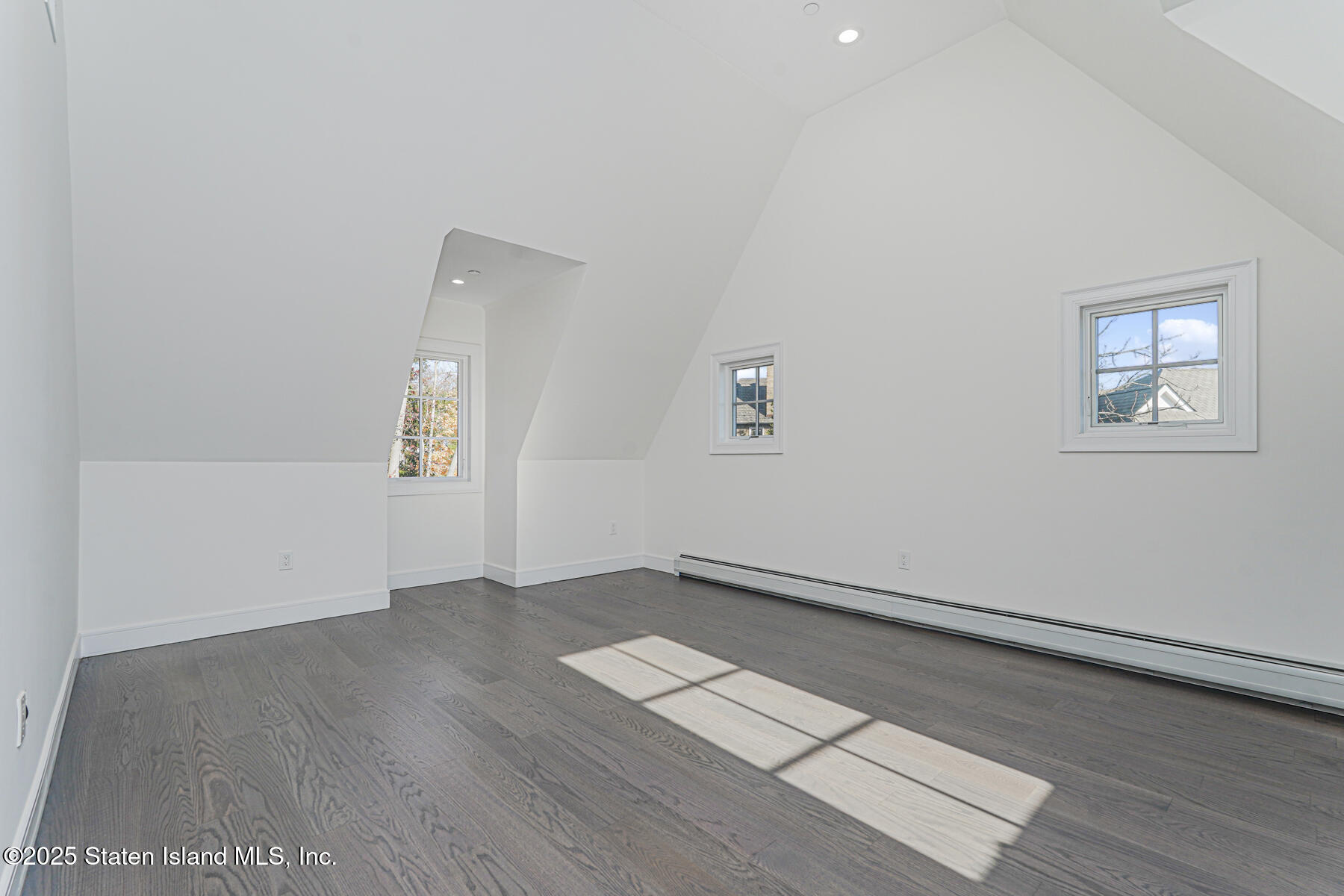 91 West Entry Road Staten Island, NY 10304 - Photo 43 of 57 an empty room with wooden floor and windows