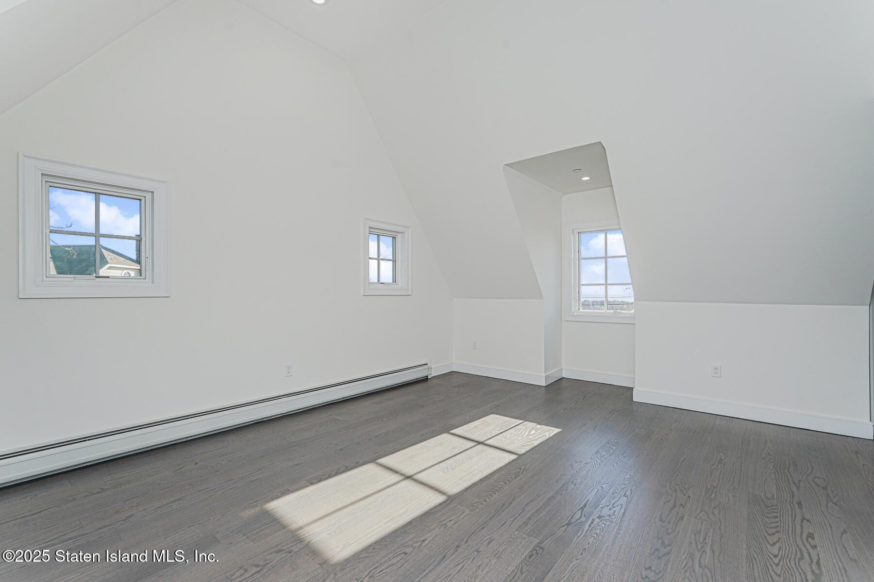 91 West Entry Road Staten Island, NY 10304 - Photo 44 of 57 an empty room with wooden floor and windows