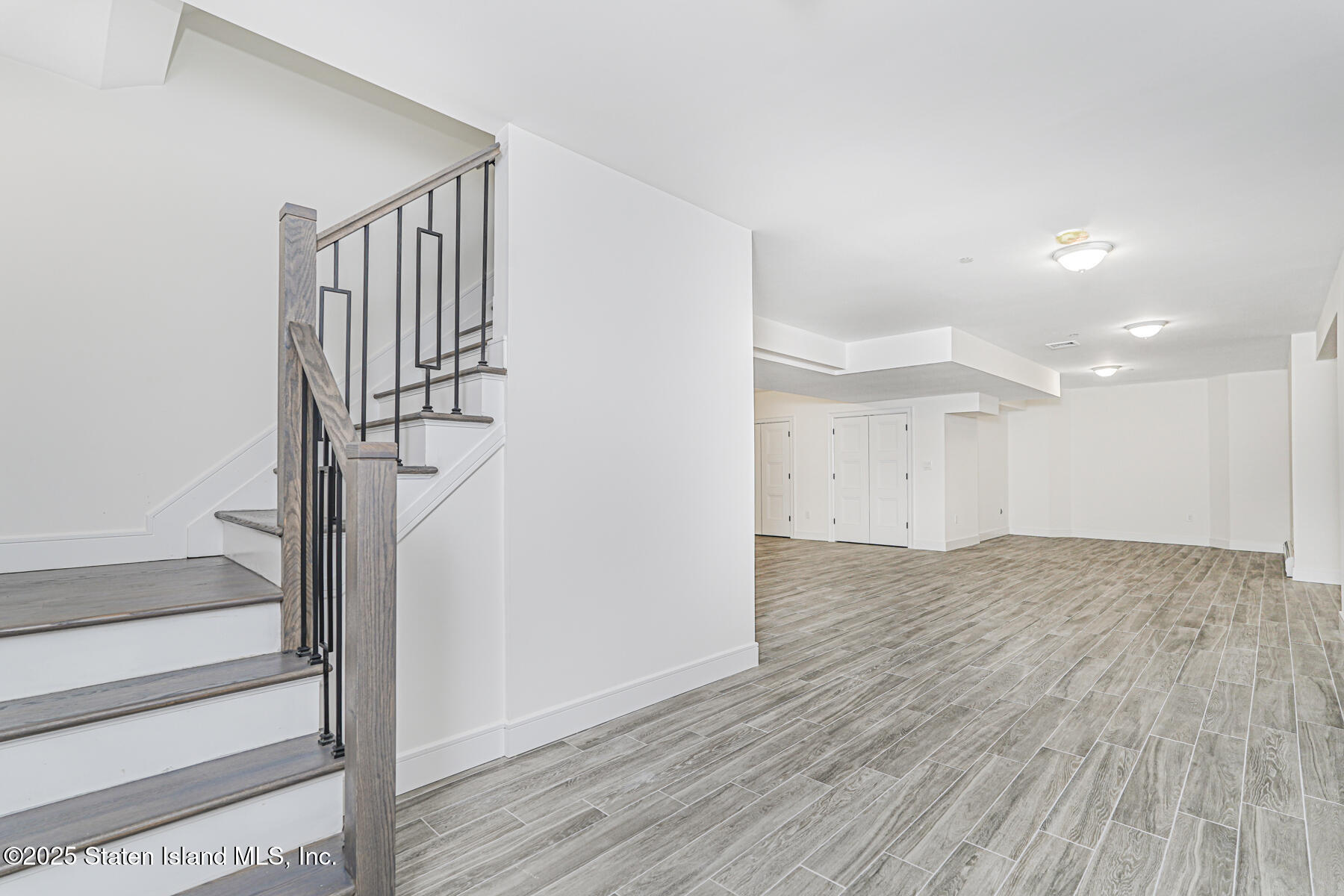91 West Entry Road Staten Island, NY 10304 - Photo 50 of 57 a view of empty room with wooden floor