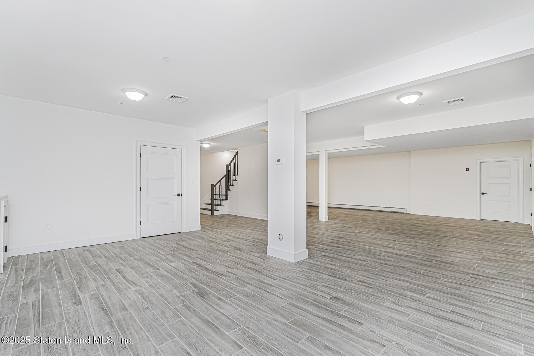 91 West Entry Road Staten Island, NY 10304 - Photo 53 of 57 a view of an empty room with wooden floor