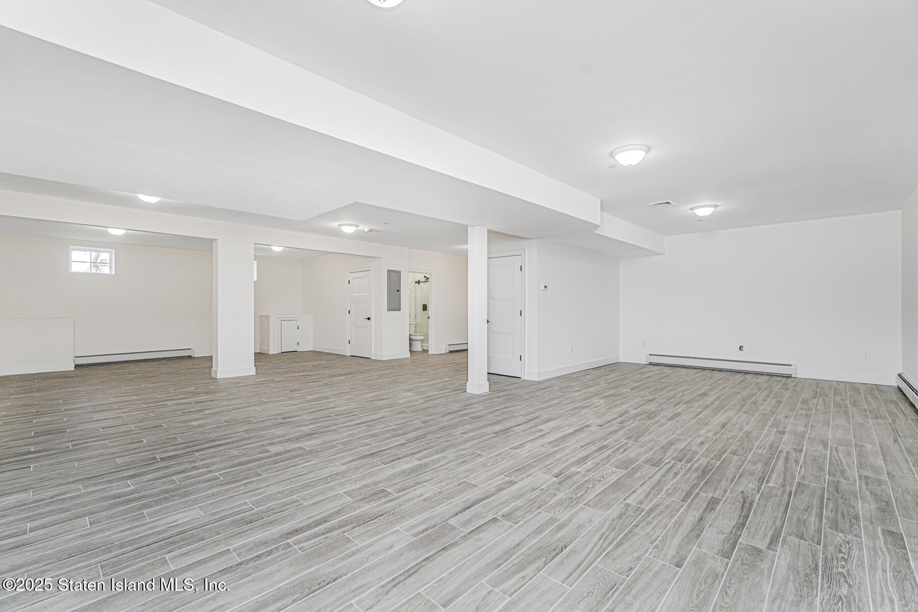 91 West Entry Road Staten Island, NY 10304 - Photo 54 of 57 a view of an empty room with wooden floor