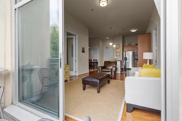a living room with furniture and a glass door shower