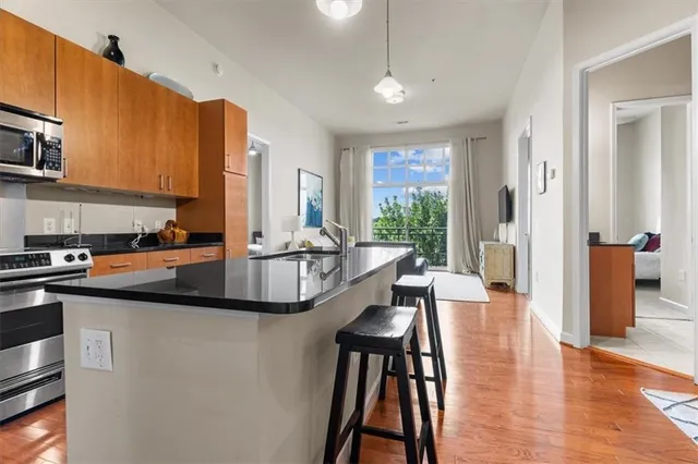 a kitchen with counter top space a sink appliances and cabinets