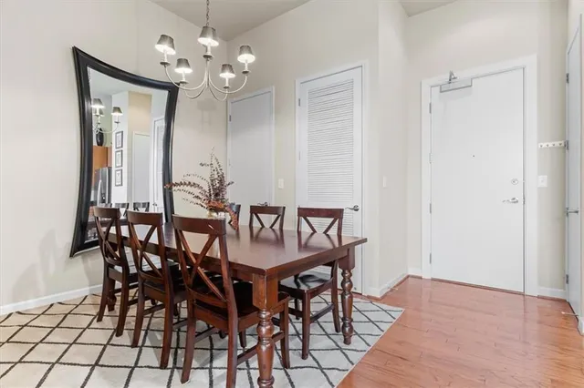 a view of a dining room with furniture and chandelier