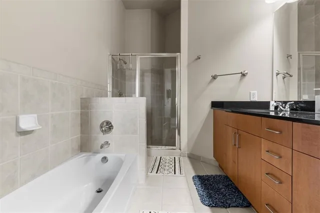 a bathroom with a granite countertop sink a toilet and bathtub