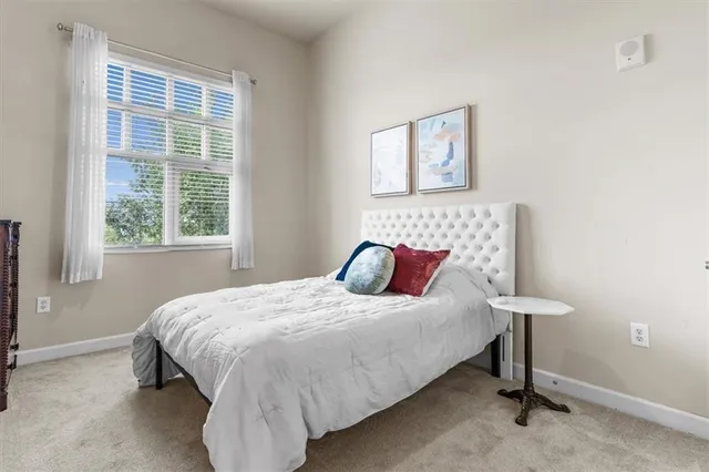 a bedroom with a bed and a lamp