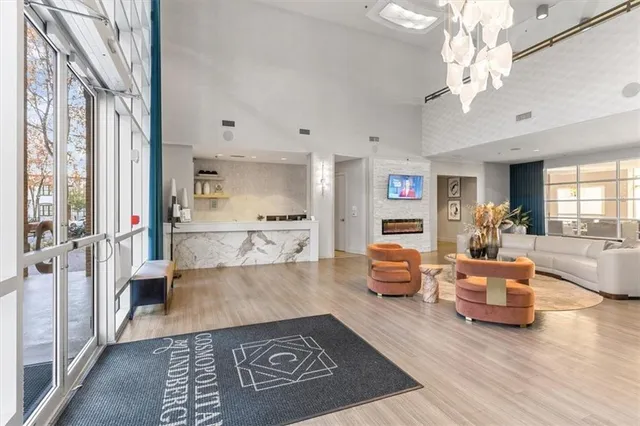 a living room with furniture and a chandelier