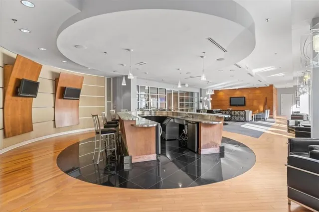 a large kitchen with stainless steel appliances granite countertop a sink and dining table