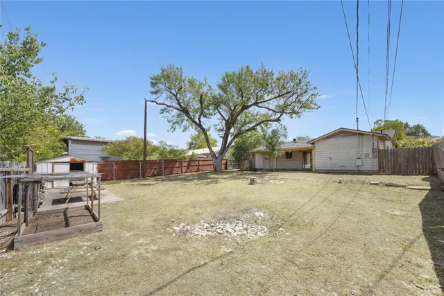 a backyard of a house with table and chairs