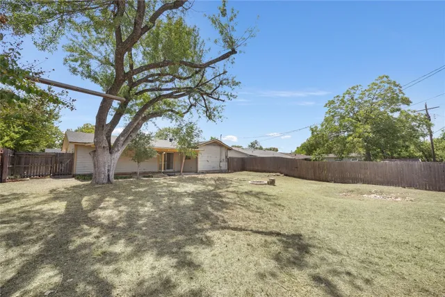 a backyard of a house with large trees