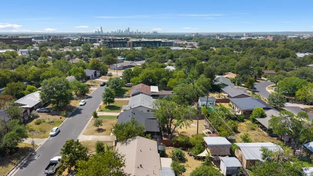 an aerial view of residential houses with city view