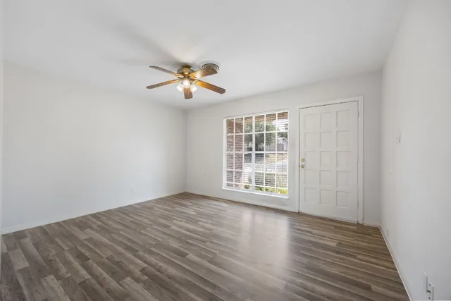 wooden floor in an empty room with a window