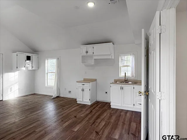 a view of kitchen with wooden floor electronic appliances and window