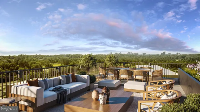 a view of a balcony with couches and city view