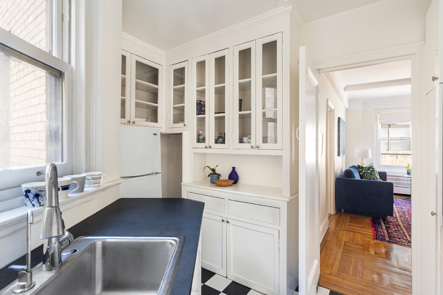 111 East 75th Street, Unit 7C Manhattan, NY 10021 - Photo 3 of 7 a view of a workspace with furniture and a window