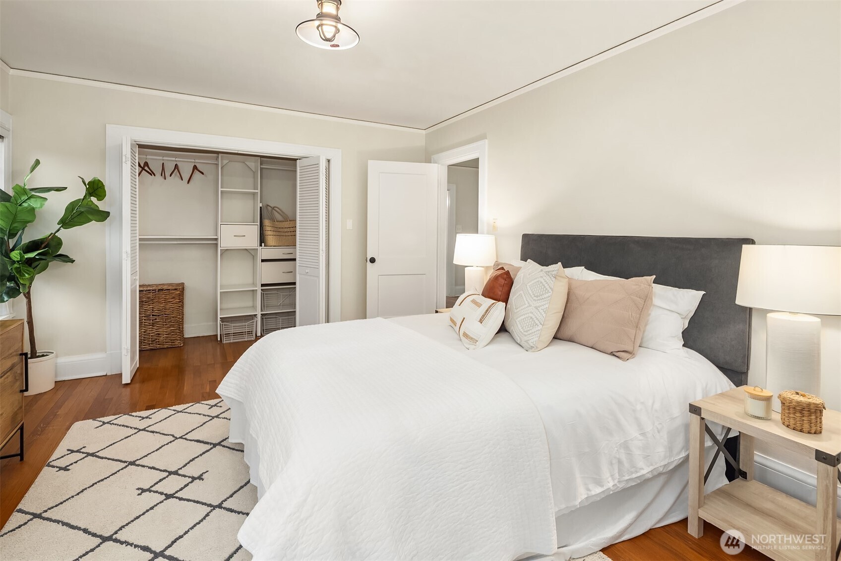 4800 Fremont Avenue North, Unit 202 Seattle, WA 98103 - Photo 11 of 30 a spacious bedroom with a bed and a potted plant