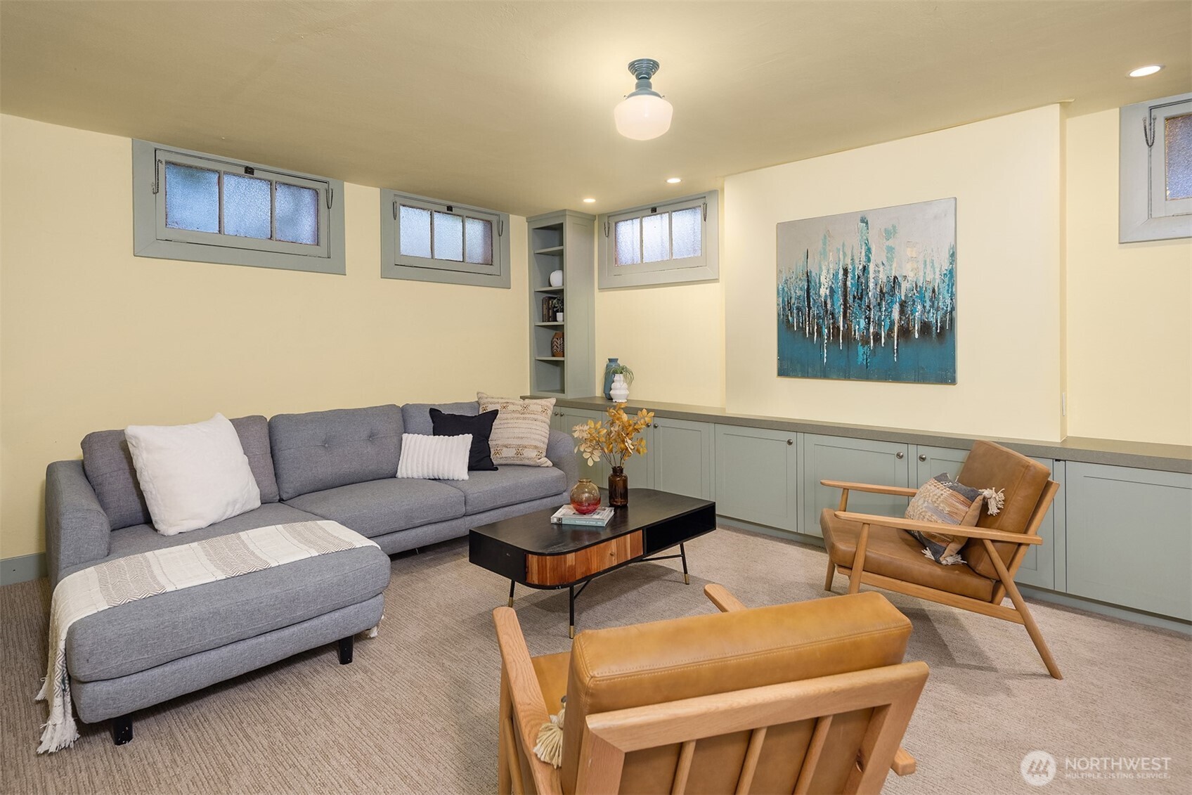 4800 Fremont Avenue North, Unit 202 Seattle, WA 98103 - Photo 18 of 30 a living room with furniture and a painting on the wall