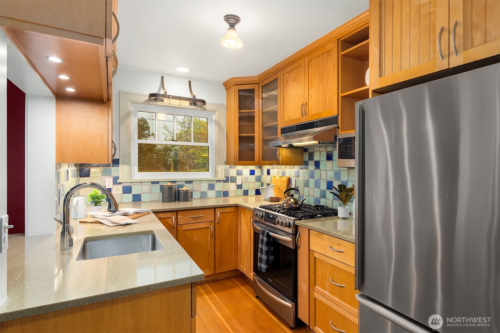 4800 Fremont Avenue North, Unit 202 Seattle, WA 98103 - Photo 9 of 30 a kitchen with stainless steel appliances a sink stove and refrigerator