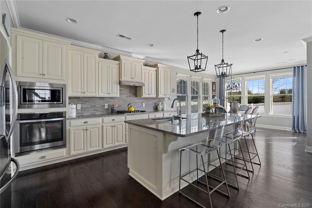 274 Helton Lane Fort Mill, SC 29708 - Photo 14 of 44 a kitchen with stainless steel appliances granite countertop a stove and white cabinets
