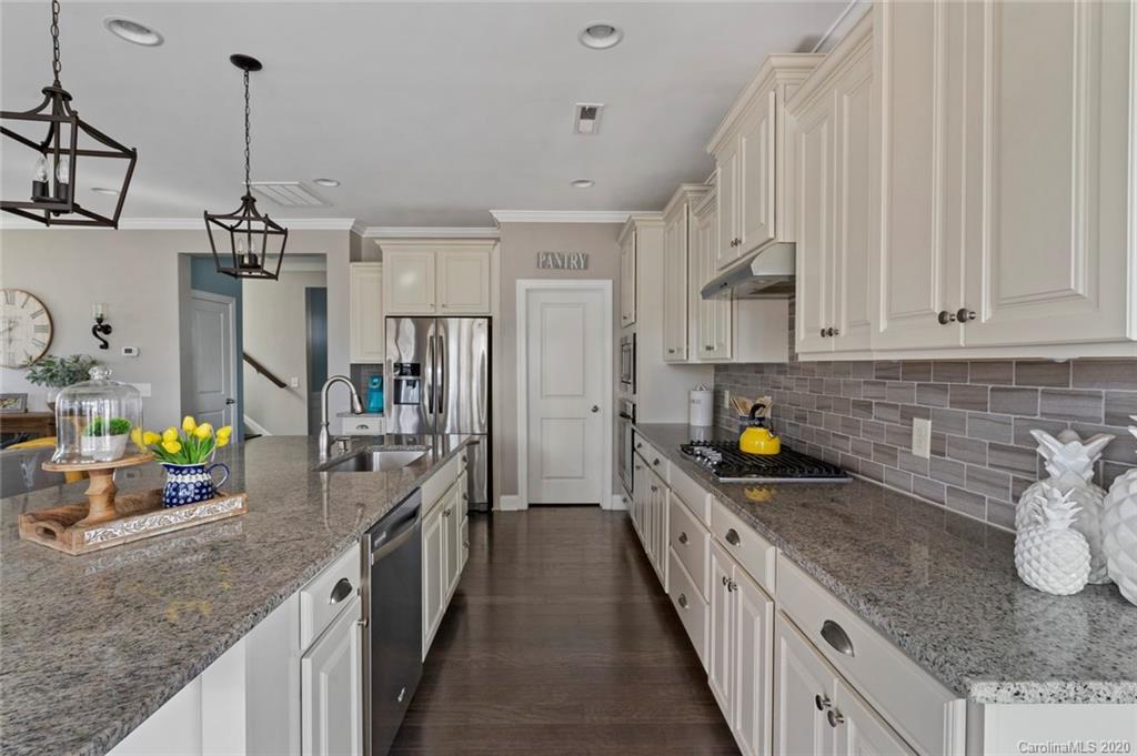 274 Helton Lane Fort Mill, SC 29708 - Photo 20 of 44 a kitchen with granite countertop a sink a counter top space appliances and cabinets